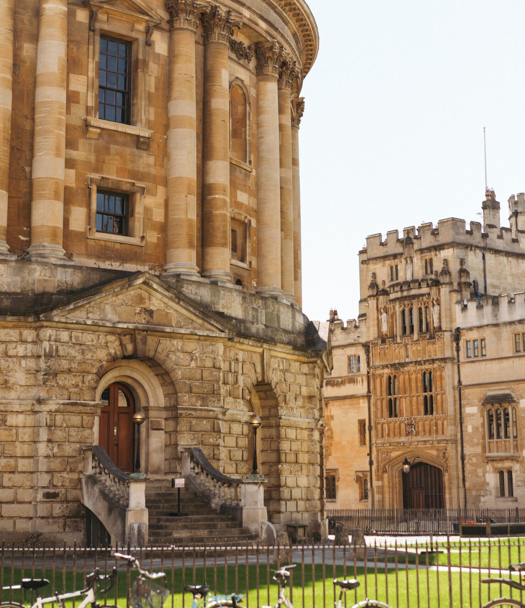 A sunny view of the iconic Radcliffe Camera and surrounding structures in Oxford, UK.